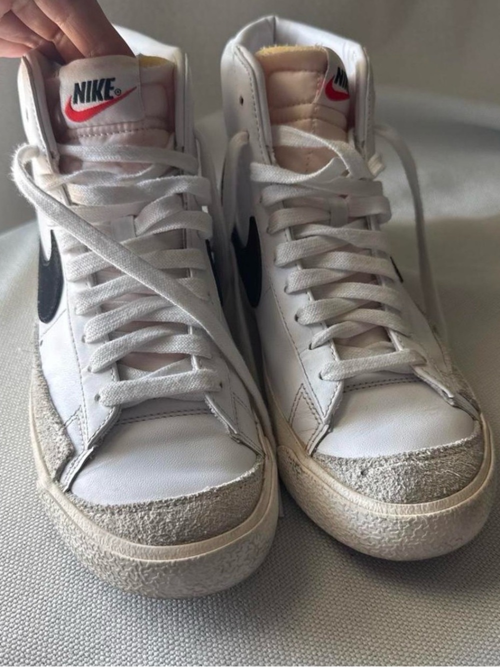 Nike White High-Top Sneakers with Black Swoosh and Red Tongue Logo